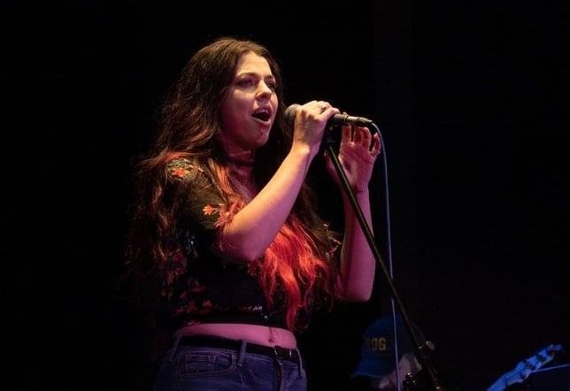 a-female-vocalist-from-deenwood-working-on-singing-techniques-on-stage