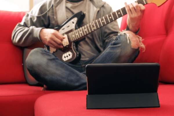 Guitar Player enrolled in an online music school in London