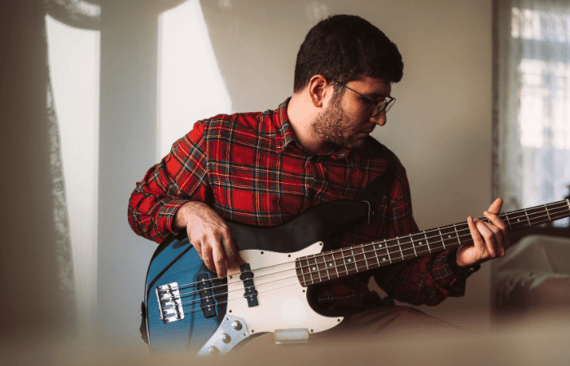 Bass player working on a riff online