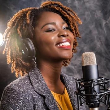 A woman recording vocals for a song that is uses AI tools following the ELVIS Act to ensure it is ethical