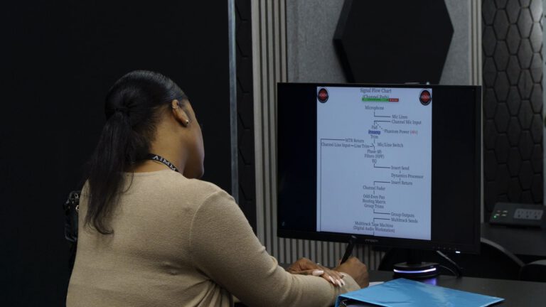 Student learning music production online using DAW software and collaborating virtually.