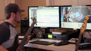 musician learning music production skills in a home studio using a DAW