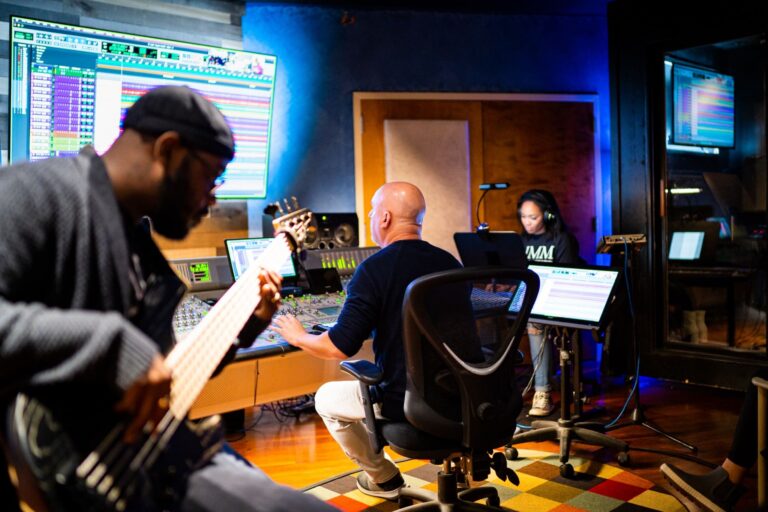 music producer using audio software in a modern tech workspace demonstrating transferable skills